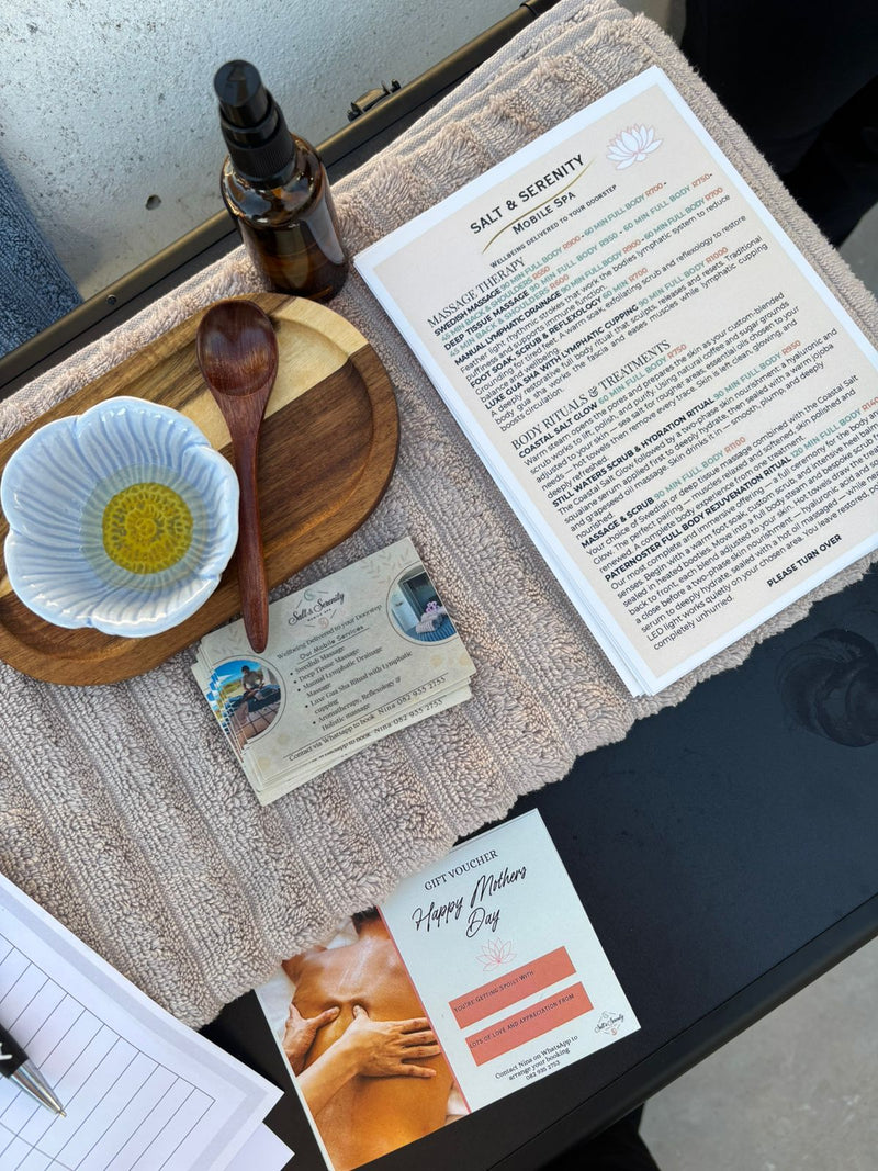 Salt and Serenity mobile spa treatment setup with massage oils towels and luxury wellness menu